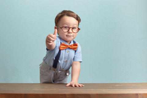 Portrait of happy little boy giving you thumbs up